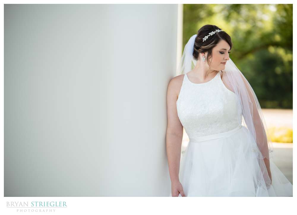 bride leaning against pillar